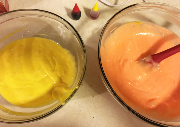 batter split into two bowls to add food coloring for candy corn cupcakes